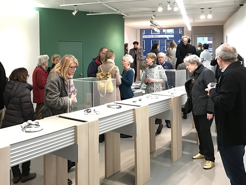 The opening of an exhibition of Terhi Tolvanen and Ralph Bakker’s work at Galerie Rob Koudijs, in March 2017. Among the attendees, you can see collector Marjan Unger (wearing a black quilted jacket and gold shoes). Other than a green wall behind the desk, the interior of Galerie Rob Koudijs was white and spare. Ralph Bakker liked how “it was neutral and gave space to the works,” photo courtesy of Galerie Rob Koudijs