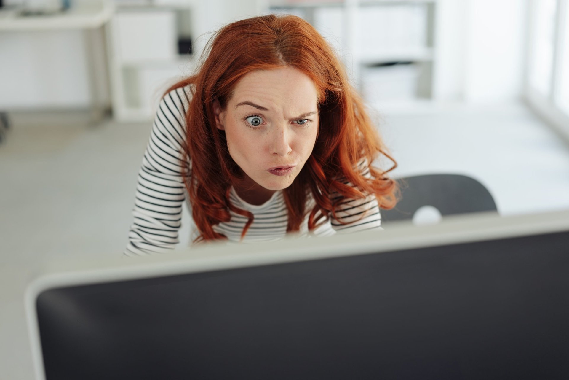 Confused woman raising one eyebrow in surprise