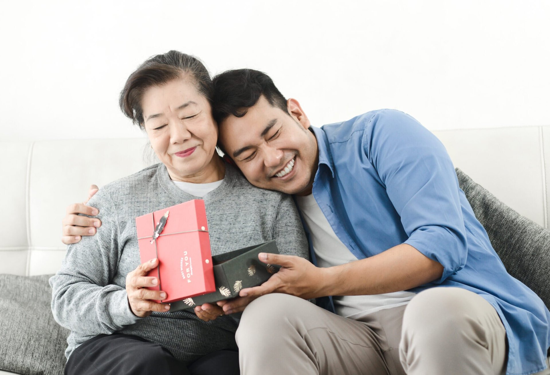 Man giving a gift to his mother