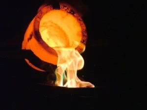 A crucible pours molten gold at a precious metals refinery