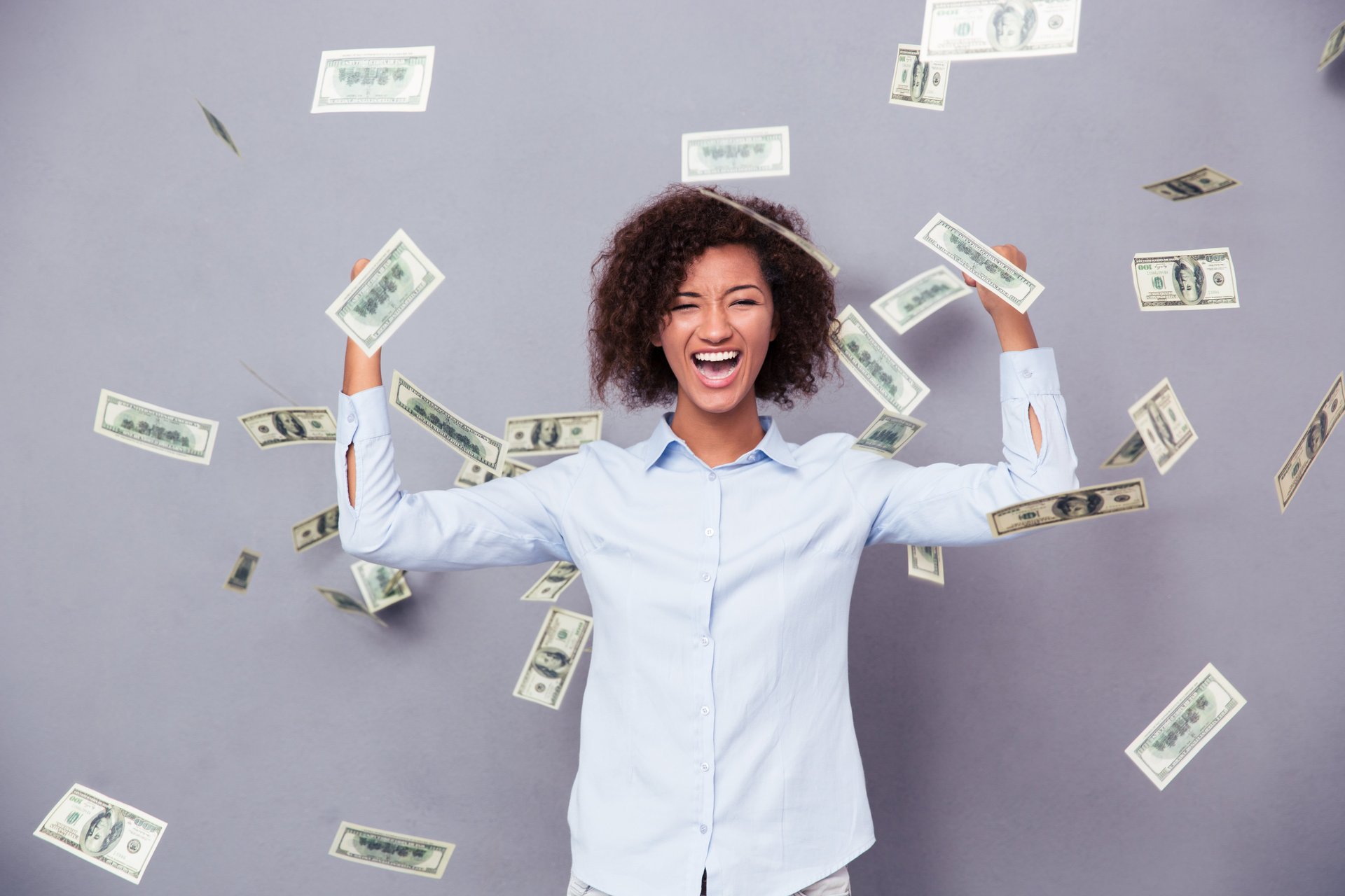 Happy woman amid falling cash.